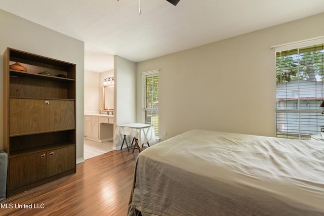 403 Suzanne Ave, Long Beach, MS 39560 - bedroom with wood finished floors and ensuite bathroom