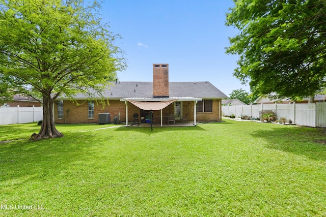 403 Suzanne Ave, Long Beach, MS 39560 - back of house with a chimney, a fenced backyard, a patio area, and brick siding