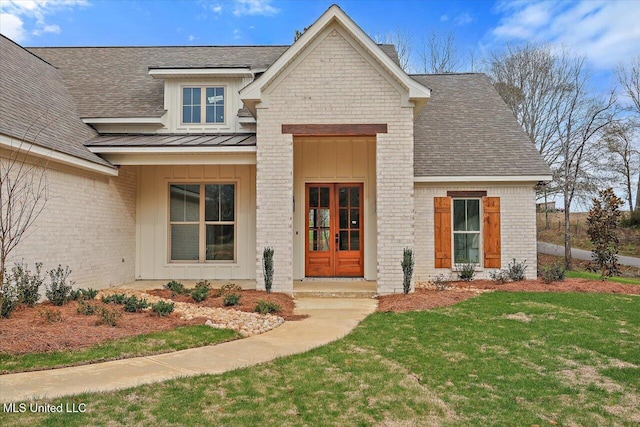 view of front of house featuring french doors and a front lawn