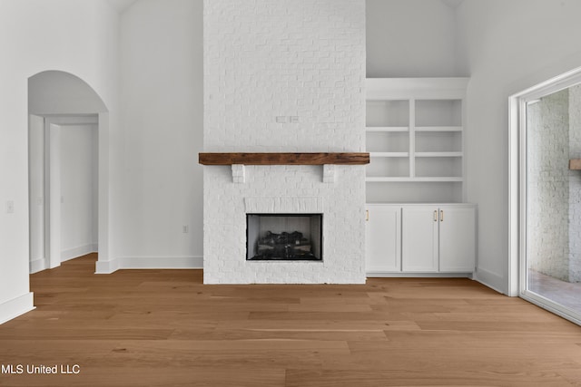 unfurnished living room with light hardwood / wood-style floors and a fireplace