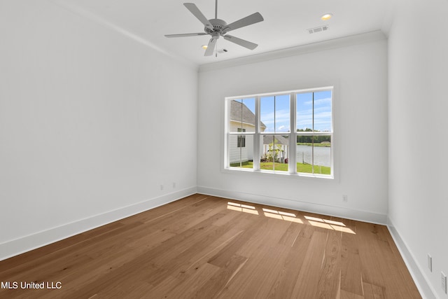 spare room featuring ornamental molding, wood-type flooring, and ceiling fan