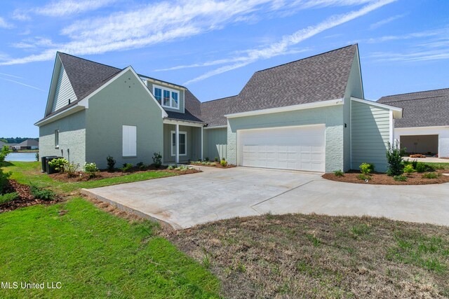 view of property featuring a front lawn and a garage