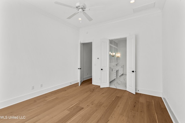 unfurnished bedroom featuring ornamental molding, hardwood / wood-style flooring, and ensuite bath