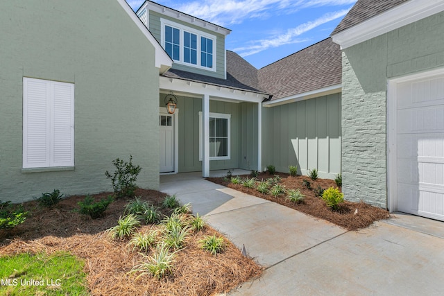 view of exterior entry with a garage