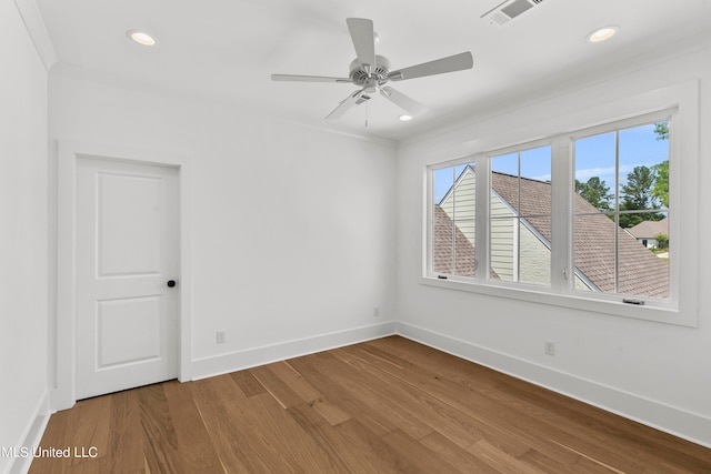 spare room featuring crown molding, hardwood / wood-style flooring, and ceiling fan