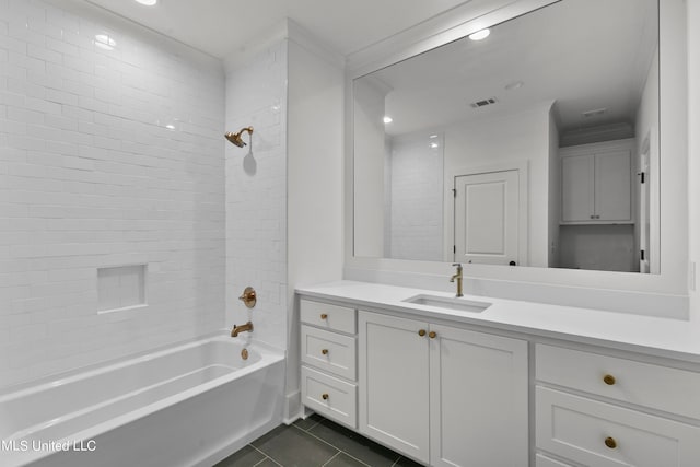 bathroom featuring vanity, tile patterned floors, and tiled shower / bath