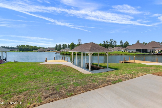 dock area with a yard and a water view