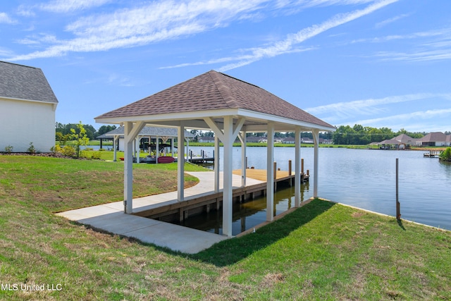 dock area featuring a water view and a lawn