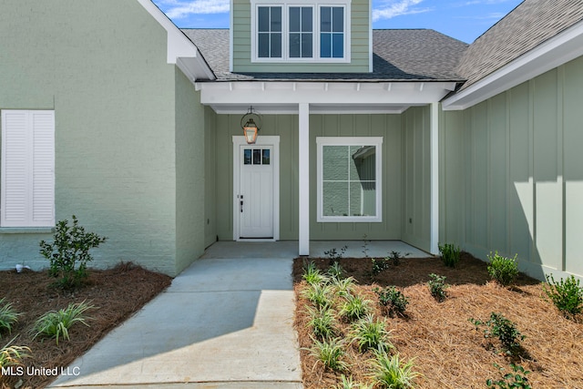 view of exterior entry featuring covered porch