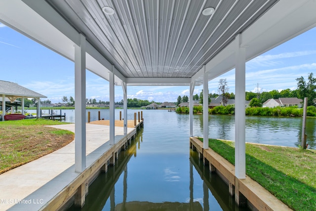 view of dock featuring a water view and a lawn