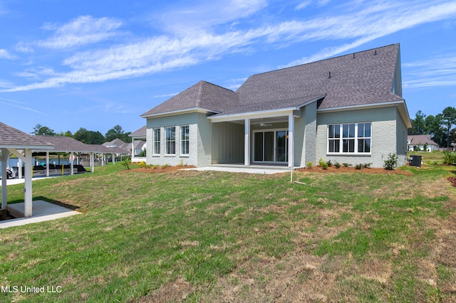 rear view of property with a yard and a patio