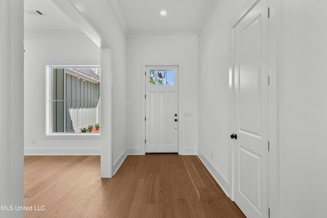 entryway featuring crown molding and hardwood / wood-style floors