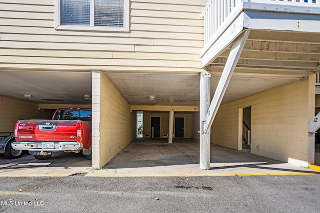 view of parking / parking lot featuring a carport