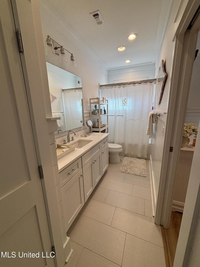 bathroom featuring vanity, visible vents, ornamental molding, and a shower with shower curtain