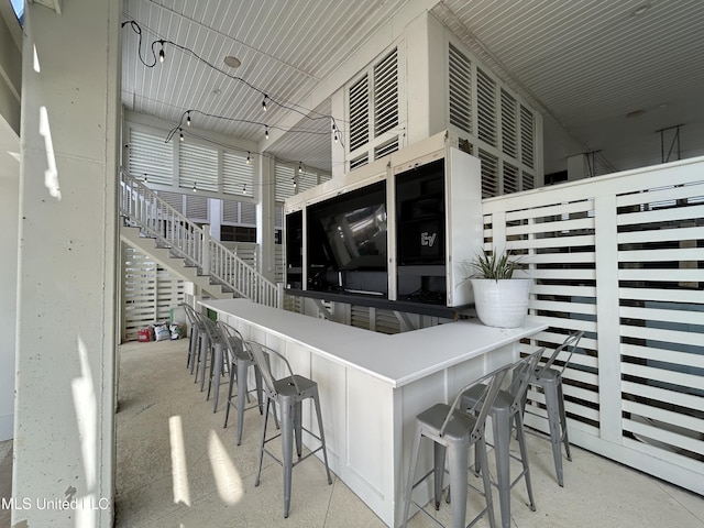 interior space with stairway and outdoor dry bar