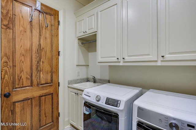 laundry area with sink, separate washer and dryer, and cabinets