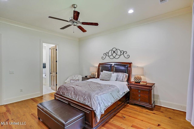 bedroom with crown molding, ensuite bathroom, light wood-type flooring, and ceiling fan