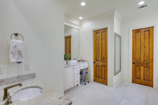 bathroom featuring vanity and an enclosed shower