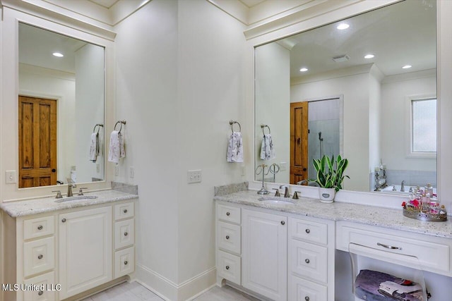 bathroom with vanity and a shower