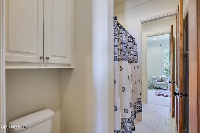 bathroom featuring toilet and tile patterned floors