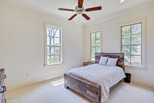 bedroom featuring ceiling fan, light carpet, and ornamental molding