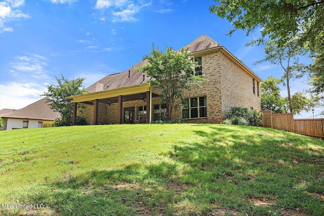 rear view of property with a yard