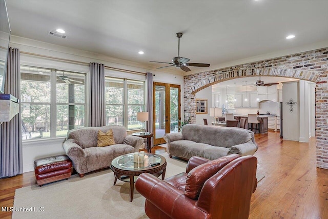 living room with light hardwood / wood-style flooring and french doors