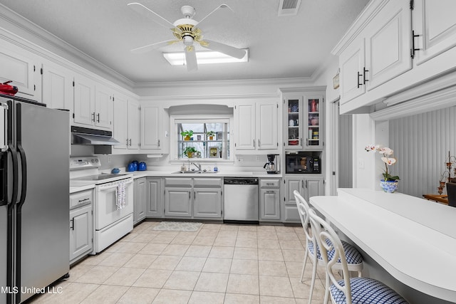 kitchen featuring appliances with stainless steel finishes, crown molding, white cabinetry, and sink