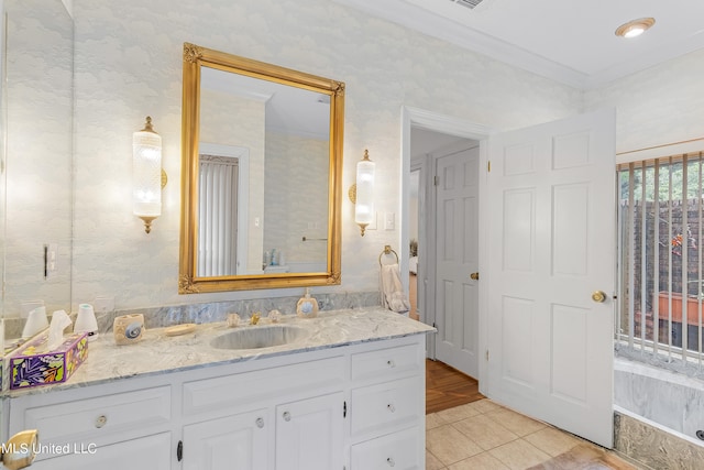 bathroom with vanity, ornamental molding, and tile patterned flooring