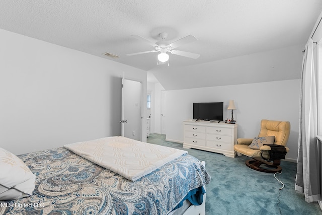 carpeted bedroom featuring a textured ceiling, vaulted ceiling, and ceiling fan