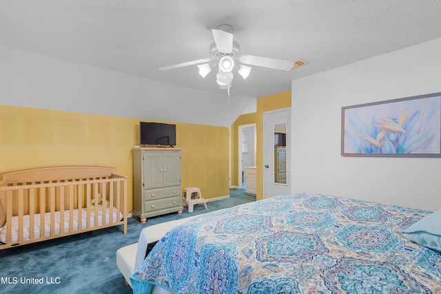 carpeted bedroom featuring a textured ceiling, vaulted ceiling, and ceiling fan