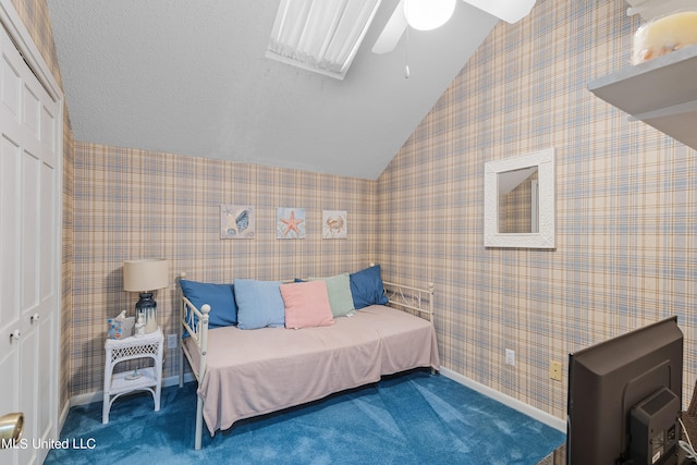 carpeted bedroom with a closet, ceiling fan, and lofted ceiling