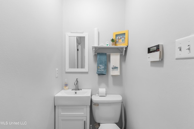 bathroom with toilet and vanity