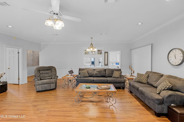 living room with crown molding, light hardwood / wood-style flooring, and ceiling fan with notable chandelier