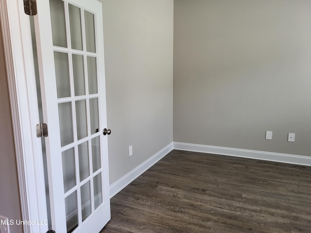 spare room with dark hardwood / wood-style flooring