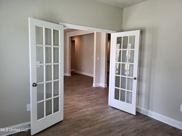 spare room featuring french doors and dark hardwood / wood-style floors