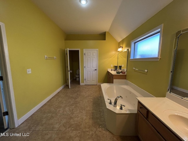 full bathroom featuring lofted ceiling, a bath, tile patterned floors, two vanities, and baseboards
