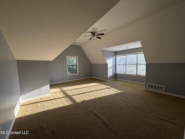 bonus room with ceiling fan, baseboards, carpet flooring, and vaulted ceiling