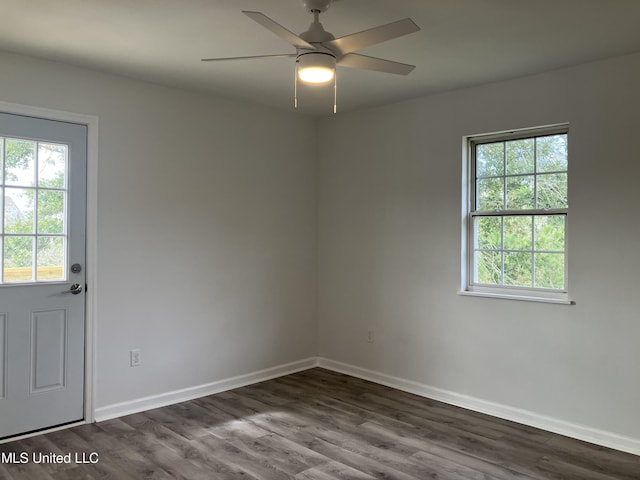 spare room featuring ceiling fan and dark hardwood / wood-style floors