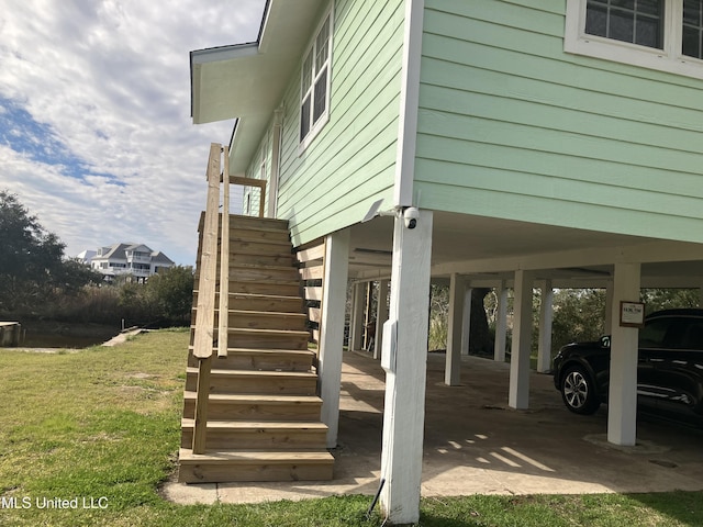 view of side of property featuring a yard and a carport