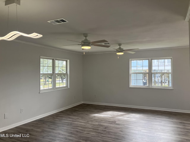 empty room with dark hardwood / wood-style flooring, ceiling fan, and crown molding