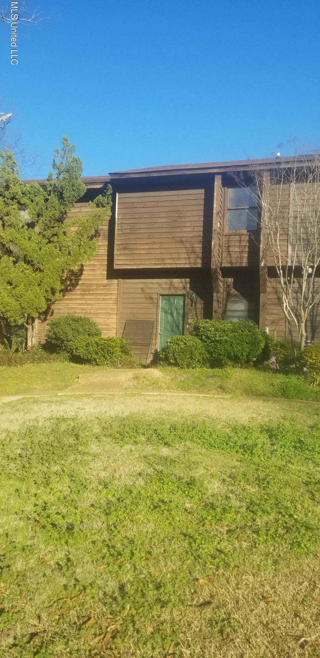 view of side of home with a lawn