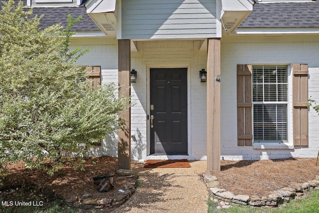 449 Abbey Woods, Brandon, MS 39047 - view of exterior entry featuring roof with shingles and brick siding