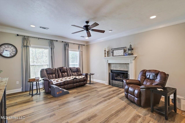 449 Abbey Woods, Brandon, MS 39047 - living area with light wood-type flooring, a ceiling fan, ornamental molding, a tile fireplace, and recessed lighting
