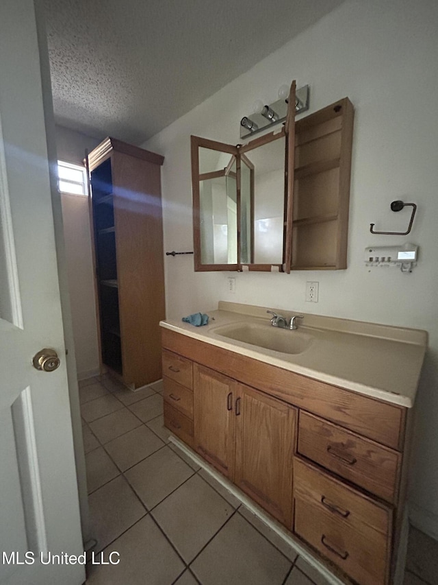 bathroom with vanity, tile patterned floors, and a textured ceiling