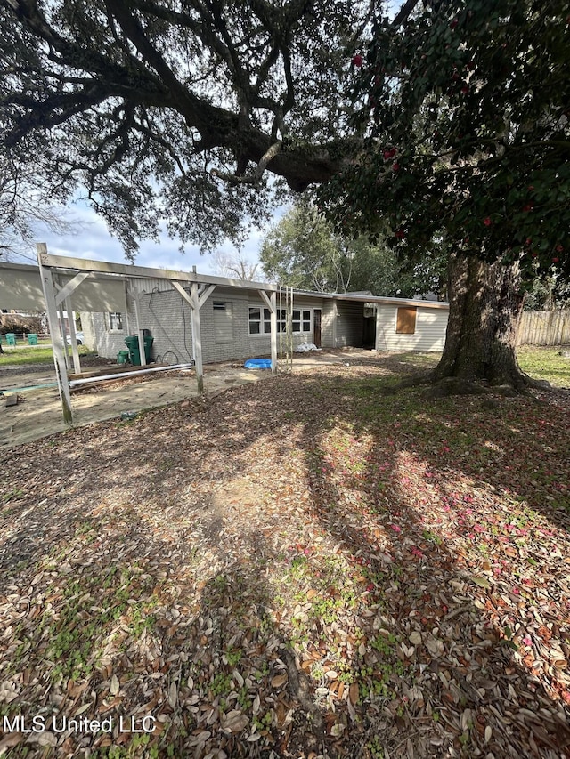 rear view of property with an attached carport