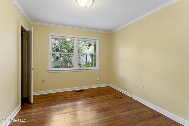 spare room featuring ornamental molding and wood-type flooring