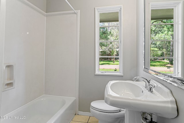 full bathroom featuring toilet, bathtub / shower combination, sink, and tile patterned floors