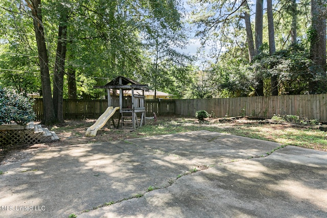 view of yard with a playground and a patio area