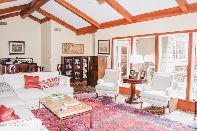 living room with high vaulted ceiling and beamed ceiling